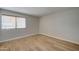 Simple bedroom with hardwood floors and large window at 3810 N Maryvale Pkwy # 1060, Phoenix, AZ 85031