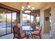 Elegant dining area with glass-top table and chairs, overlooking a pool and desert landscape at 39565 N 107Th Way, Scottsdale, AZ 85262