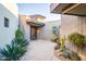 Inviting entry courtyard with native plants and stone pathway to the front door at 39565 N 107Th Way, Scottsdale, AZ 85262