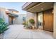 Modern home exterior with courtyard entry and wooden door at 39565 N 107Th Way, Scottsdale, AZ 85262