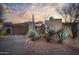 Desert landscape surrounds this contemporary home with a large garage and inviting entryway at 39565 N 107Th Way, Scottsdale, AZ 85262