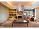 Living room with a stone fireplace and built-in shelving at 39565 N 107Th Way, Scottsdale, AZ 85262