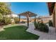 Landscaped backyard with pergola and grass at 4058 E Mesquite St, Gilbert, AZ 85296