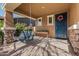 Relaxing front porch with a wooden swing and decorative wreath at 4058 E Mesquite St, Gilbert, AZ 85296