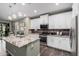 Modern kitchen with white cabinets, granite island, and stainless steel appliances at 4058 E Mesquite St, Gilbert, AZ 85296