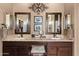 Elegant bathroom with dual sinks, large mirrors, and granite countertop at 41711 N Maidstone Ct, Anthem, AZ 85086