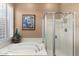 Relaxing bathroom with soaking tub and separate shower at 41711 N Maidstone Ct, Anthem, AZ 85086