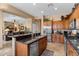 Island kitchen with granite countertops, stainless steel appliances, and wooden cabinets at 41711 N Maidstone Ct, Anthem, AZ 85086