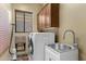 Convenient laundry room with washer, dryer, and utility sink at 41711 N Maidstone Ct, Anthem, AZ 85086