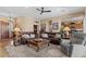 Spacious living room featuring comfortable leather sofas and a rustic coffee table at 41711 N Maidstone Ct, Anthem, AZ 85086