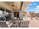 Covered patio with seating area, ceiling fan, and outdoor kitchen at 41711 N Maidstone Ct, Anthem, AZ 85086