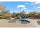 Inviting pool and spa with waterfall feature in a desert landscape setting at 41711 N Maidstone Ct, Anthem, AZ 85086