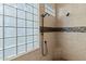 Clean shower with glass block window and modern fixtures at 41711 N Maidstone Ct, Anthem, AZ 85086