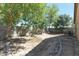 Landscaped backyard with mature trees at 46166 W Sheridan Rd, Maricopa, AZ 85139