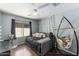 Cozy bedroom with hanging chair and window at 46166 W Sheridan Rd, Maricopa, AZ 85139