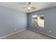 Spacious bedroom with ceiling fan and large window at 46166 W Sheridan Rd, Maricopa, AZ 85139