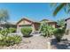 House exterior with a two-car garage and drought-tolerant landscaping at 46166 W Sheridan Rd, Maricopa, AZ 85139