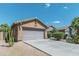 House exterior featuring a two-car garage and desert landscaping at 46166 W Sheridan Rd, Maricopa, AZ 85139