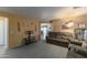 Living room with brown couches and carpeting at 46166 W Sheridan Rd, Maricopa, AZ 85139