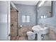 Bathroom with white pedestal sink, tiled shower, and a mirror at 4626 S 8Th St, Phoenix, AZ 85040