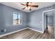 Bedroom with gray walls, wood-look floors, and a window at 4626 S 8Th St, Phoenix, AZ 85040