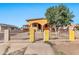 Cute yellow house with arched entryway and a metal fence at 4626 S 8Th St, Phoenix, AZ 85040