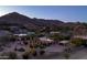 Aerial perspective of the house and surrounding neighborhood at dusk at 4836 E Moonlight Way, Paradise Valley, AZ 85253