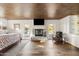 Main bedroom with fireplace, hardwood floors, and sliding glass doors to a pool view at 4836 E Moonlight Way, Paradise Valley, AZ 85253