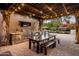 Outdoor kitchen with built-in grill, stone countertops, and pergola at 4836 E Moonlight Way, Paradise Valley, AZ 85253