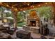 Outdoor patio with stone fireplace and seating area at 4836 E Moonlight Way, Paradise Valley, AZ 85253