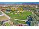 Scenic aerial view showing a sprawling park with a pond and community gardens at 5015 S Quantum Way, Mesa, AZ 85212