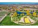 Aerial view of a community park with pond, playground, and walking paths at 5015 S Quantum Way, Mesa, AZ 85212