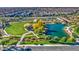 Aerial view of a community park with pond, playground, and walking paths at 5015 S Quantum Way, Mesa, AZ 85212