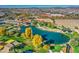 Aerial view of a community park with pond, playground, and walking paths at 5015 S Quantum Way, Mesa, AZ 85212