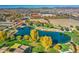 Aerial view of a community park with pond, playground, and walking paths at 5015 S Quantum Way, Mesa, AZ 85212