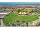 Aerial view of a community park with a pond, playground, and community gardens at 5015 S Quantum Way, Mesa, AZ 85212