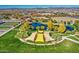 Aerial view of a community park with pond, playground, and walking paths at 5015 S Quantum Way, Mesa, AZ 85212