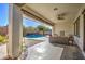 Covered patio overlooks a sparkling pool with a water feature; perfect for relaxation at 5015 S Quantum Way, Mesa, AZ 85212