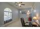 Home office features an arched window and built-in shelving at 5015 S Quantum Way, Mesa, AZ 85212