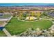 Aerial view of a community park with a pond, playground, and community gardens at 5015 S Quantum Way, Mesa, AZ 85212