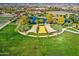 Aerial view of a community park with pond, shade structures, and lush landscaping at 5015 S Quantum Way, Mesa, AZ 85212