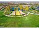 Aerial view of a community park with pond, shade structures, and lush landscaping at 5015 S Quantum Way, Mesa, AZ 85212