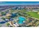 Aerial view of community pool, clubhouse, and surrounding landscape at 5015 S Quantum Way, Mesa, AZ 85212