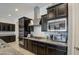 Stylish kitchen with dark cabinetry, stainless steel appliances and granite countertops at 5015 S Quantum Way, Mesa, AZ 85212