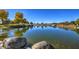 Tranquil pond view with large rocks and reflections at 5015 S Quantum Way, Mesa, AZ 85212