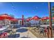 Outdoor patio dining area with red umbrellas and string lights at 5015 S Quantum Way, Mesa, AZ 85212