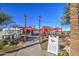 Outdoor restaurant patio with red umbrellas and string lights at 5015 S Quantum Way, Mesa, AZ 85212