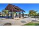 Covered gazebo with picnic tables near lake at 5015 S Quantum Way, Mesa, AZ 85212