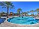 Community pool with a water feature and lounge chairs at 5015 S Quantum Way, Mesa, AZ 85212