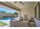 Relaxing covered patio with wicker furniture overlooking a sparkling pool at 5015 S Quantum Way, Mesa, AZ 85212